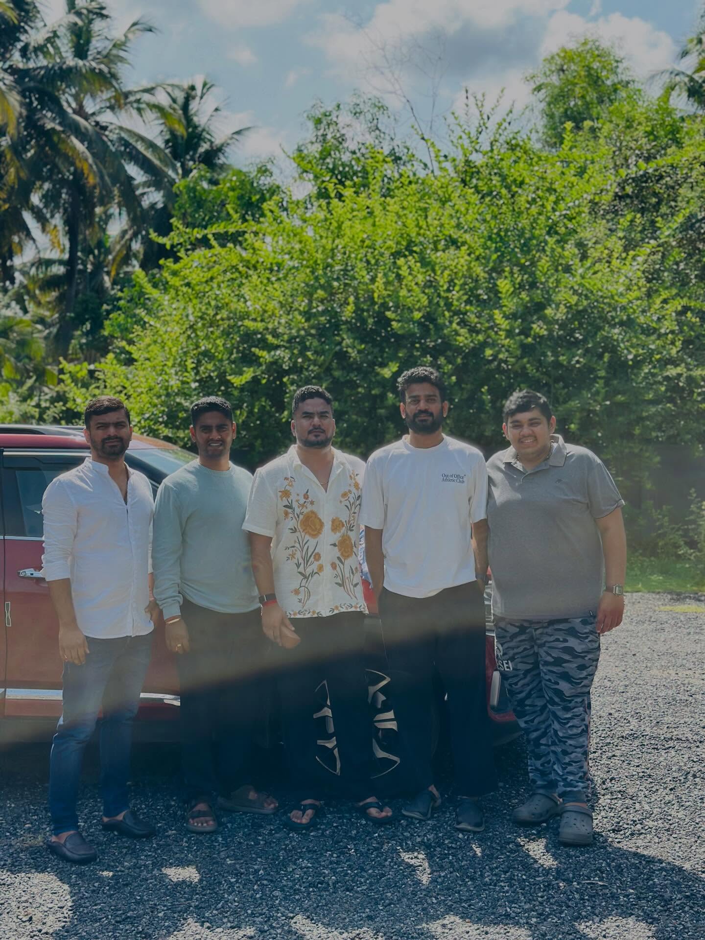 Friends posing together by the coconut trees at Konkan Kuteera Kundapura